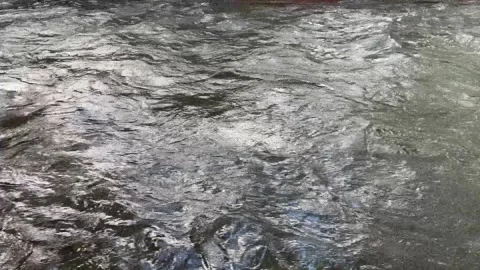 Flowing Stream Water With Blue Reflections And Soft Ripples, High Angle 4K Stock-Footage 347596188