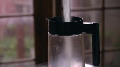 Flowing sugar pouring smoothly into a clear plastic jar during morning tea Video stock 335835775