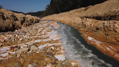 Flowing toxic gold mining residual metal-rich water contaminates ecosystems Stock Footage 337693830