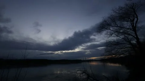 Flowing Vistula river with cloudy sunset, clouds, orange sky Stock Footage 237470052
