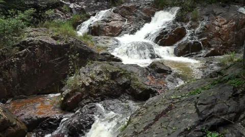 Flowing water of cascade waterfall on rocks in deep tropical forest at hot Stock Footage 67425864