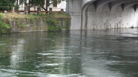 Flowing water in cold river via old stone bridge Stock Footage 92694829