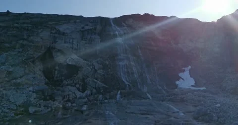Flowing water from a glacial waterfall flows into the sea Video stock 148197744