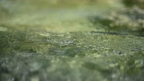 Flowing water from a mountain stream in the evening (abstract, slow motion) Video stock 260843690