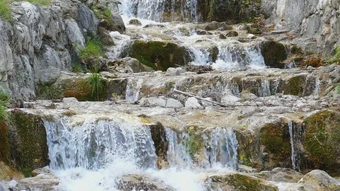 Flowing water of a mountain stream with waterfall Stockbeeldmateriaal 98534880
