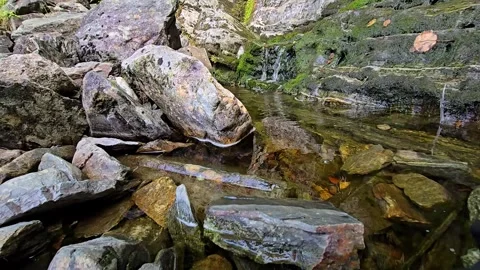 Flowing water over layered rocks at Starefossen waterfall Stock Footage 340583056