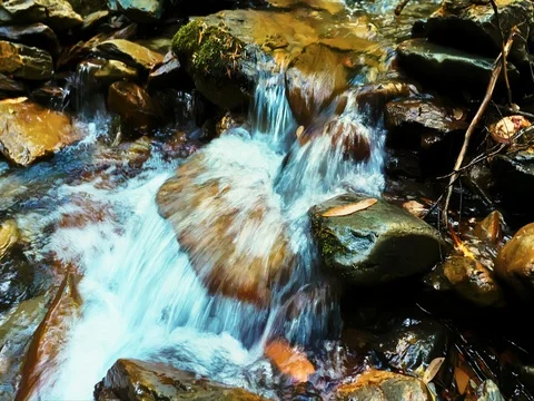 Flowing water over rocks Stock Footage 77046433