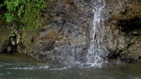 Flowing water plunges into a river Stock Footage 292674932