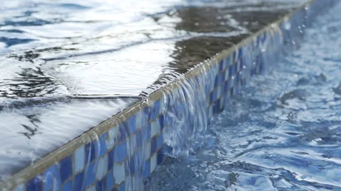 Flowing water from the pool, a small waterfall in the fountain Stock Footage 94926605