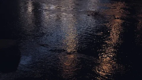 Flowing water in the river at night. Reflection of the moon and city lights i 動画素材 96271569
