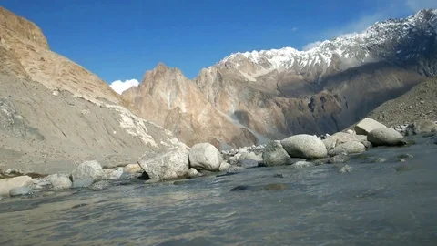 Flowing water stream among the mountain range in Passu. Stock Footage 96055939
