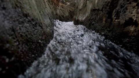 Flowing Water Stream Through Narrow Stone Channel in Park Stock Footage 334622333