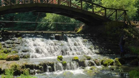 Flowing water Stream under Vrelo Bosne Bridge at outskirts of Sarajevo Stock Footage 219892488
