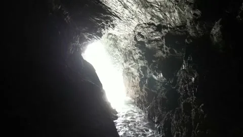 Flowing water surrounded by cliffs in cave Video stock 229255316