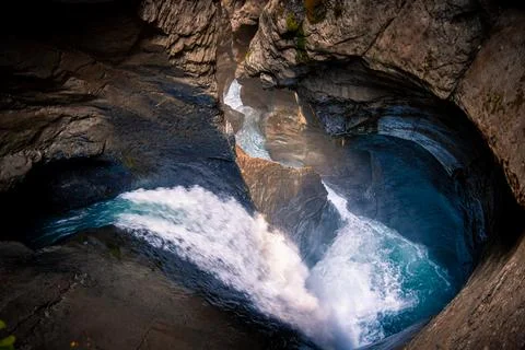 Flowing water of a waterfall inside a mountain Stock Photos