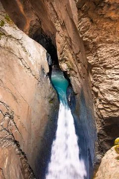 Flowing water of a waterfall inside a mountain Stock Photos