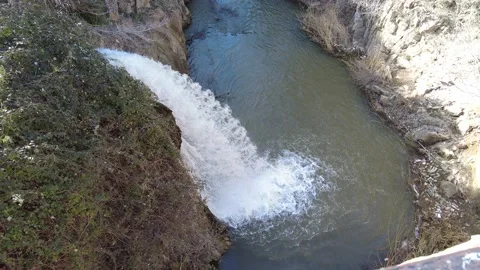 Flowing waterfall on sunny day. Stock Footage 229824465