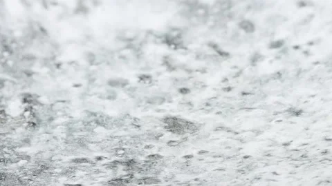 Flowing white foam of detergent from the windshield of a car. Stock Footage 195412992