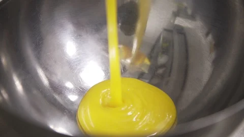 Flowing yellow glaze into bowl for eclair Stock Footage 96205397