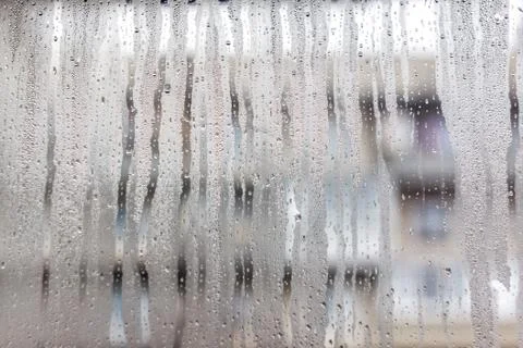 Flows on the misted window-glass. Close-up. Background Stock Photos