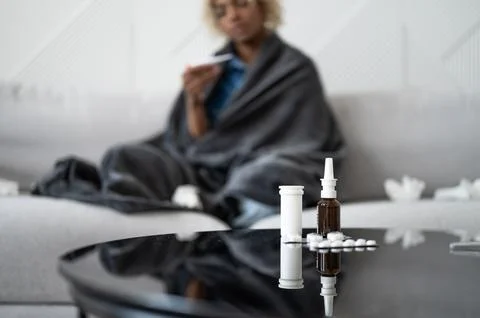 Flu and cold concept.Copyspace banner with black woman with fever on the couch Stock Photos