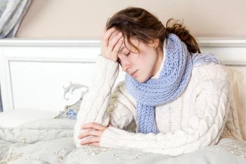 Flu or cold. Closeup top view image of frustrated young woman with blue scarf Foto stock