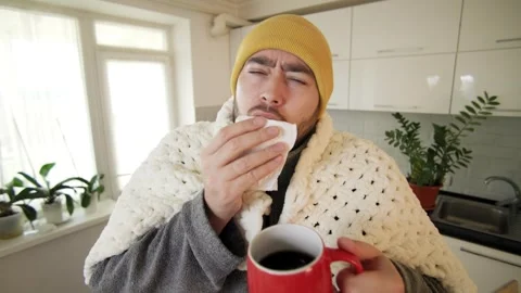 Flu Realities Bearded Man Wraps Up in Duvet at Home Vídeos de archivo 260220001