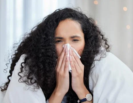 The flu is very unpredictable when it begins. an uncomfortable looking young Stock Photos