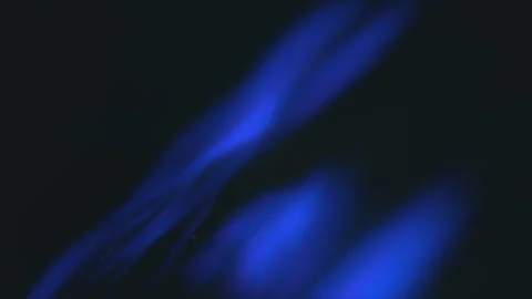 Fluctuating blue flame engulfed in black smoke Stockbeeldmateriaal 315163978