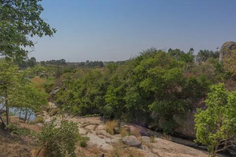 Fluent river with rocks and vegetation in Africa. Lubango. Angola. Stock Photos