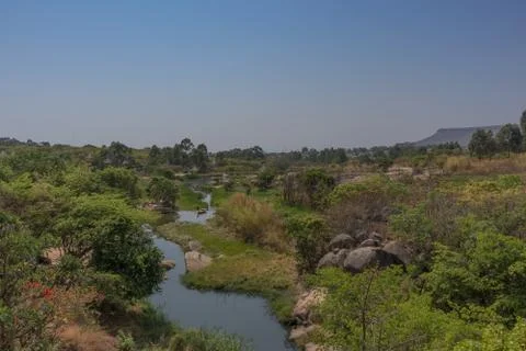 Fluent river with rocks and vegetation in Africa. Lubango. Angola. Stock Photos