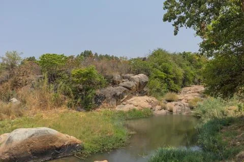 Fluent river with rocks and vegetation in Africa. Lubango. Angola. Stock Photos