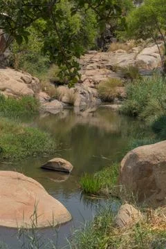 Fluent river with rocks and vegetation in Africa. Lubango. Angola. Stock Photos