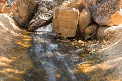 Fluent in water with stones. Stock Photos