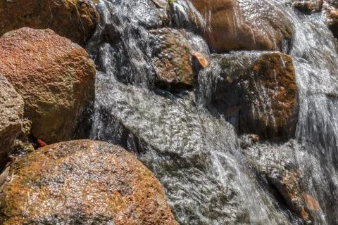 Fluent in water with stones. Stock Photos