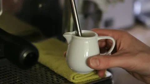 Fluffing milk in coffee cup by machine tube Stock Footage 11482242