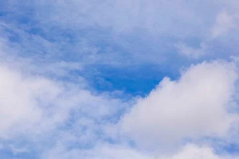 Fluffy blue sky with soft clouds Stock Photos