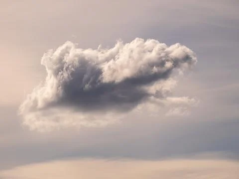 A fluffy cloud in a hazy sky Stock Photos
