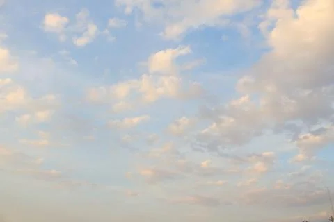 Fluffy cloud with orange light sky background. Stock Photos