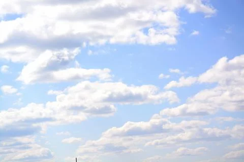 Fluffy cloud in a saturated blue sky.	13 Stock Photos