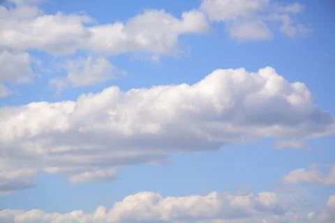 Fluffy cloud in a saturated blue sky.	4 Stock Photos