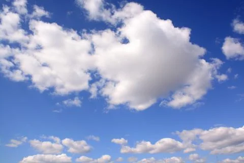 Fluffy cloud in a saturated blue sky.	 Stock Photos