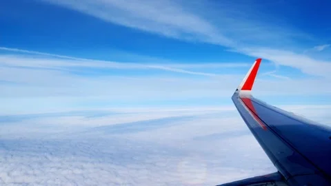 Fluffy clouds and blue sky. a multicolored sun bunny on the clouds is moving Stock Footage 164448826