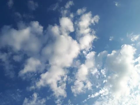 Fluffy clouds and blue sky Stock Photos