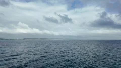 Fluffy Clouds and Rippling Ocean Waters Stock Footage 298279875