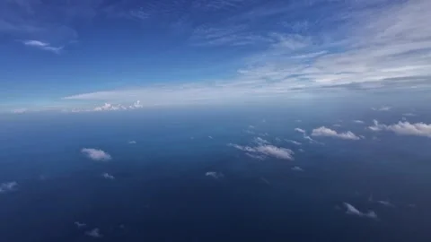 Fluffy clouds and sky as seen through window of an aircraft Stock Footage 299320015