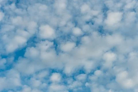 Fluffy clouds on a blue background Stock Photos