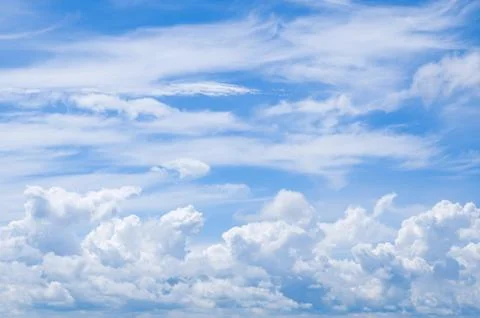 Fluffy clouds in blue sky Stock Photos