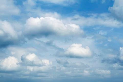 Fluffy clouds in a blue sky Stock Photos
