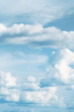 Fluffy clouds in a blue sky Stock Photos